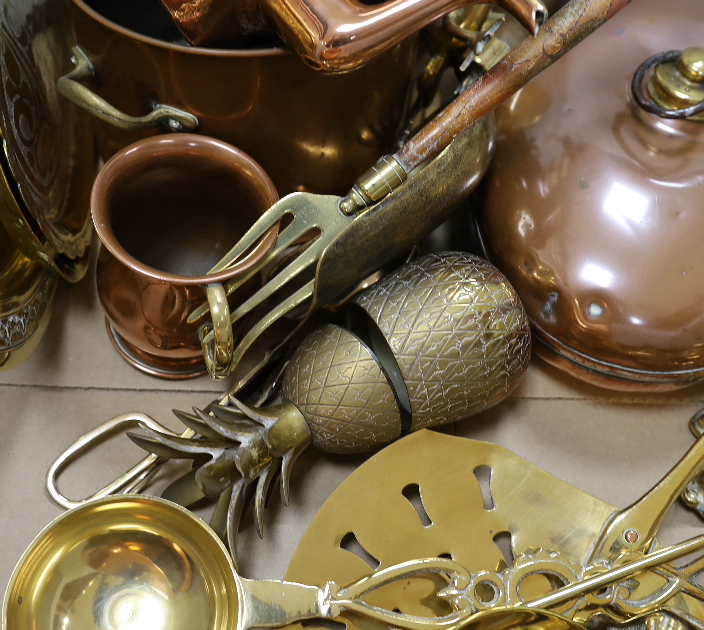 A group of mixed copper and brass including a warming pan, kettle, pot etc